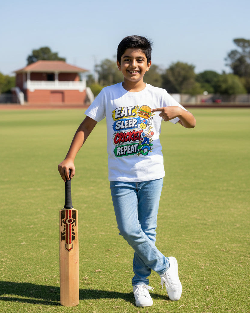 A white short-sleeve t-shirt with a colorful graphic print on the front that reads 'EAT. SLEEP, CRICKET, REPEAT.