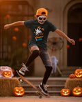 A black short-sleeve kids' t-shirt with a colorful graphic of a cartoon ghost riding a skateboard, surrounded by jack-o'-lanterns and the text 'Spooky & Cool' in orange and blue.