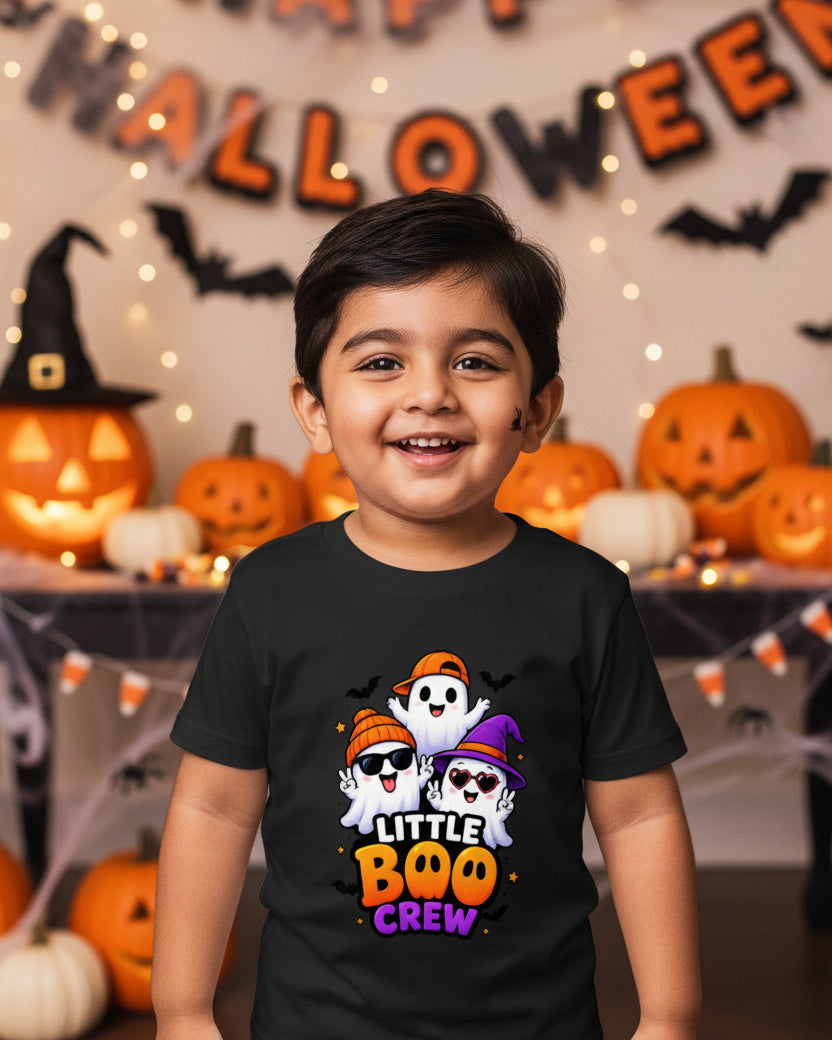 A black short-sleeve kids' t-shirt with a colorful graphic of three cartoon ghosts wearing orange and purple hats above the text 'LITTLE BOO CREW' in orange and purple, shown on a light gray background.