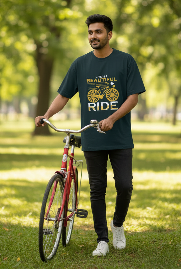 A dark teal short-sleeve t-shirt with a graphic print on the front featuring a yellow bicycle and the text 'LIFE IS A BEAUTIFUL RIDE'.